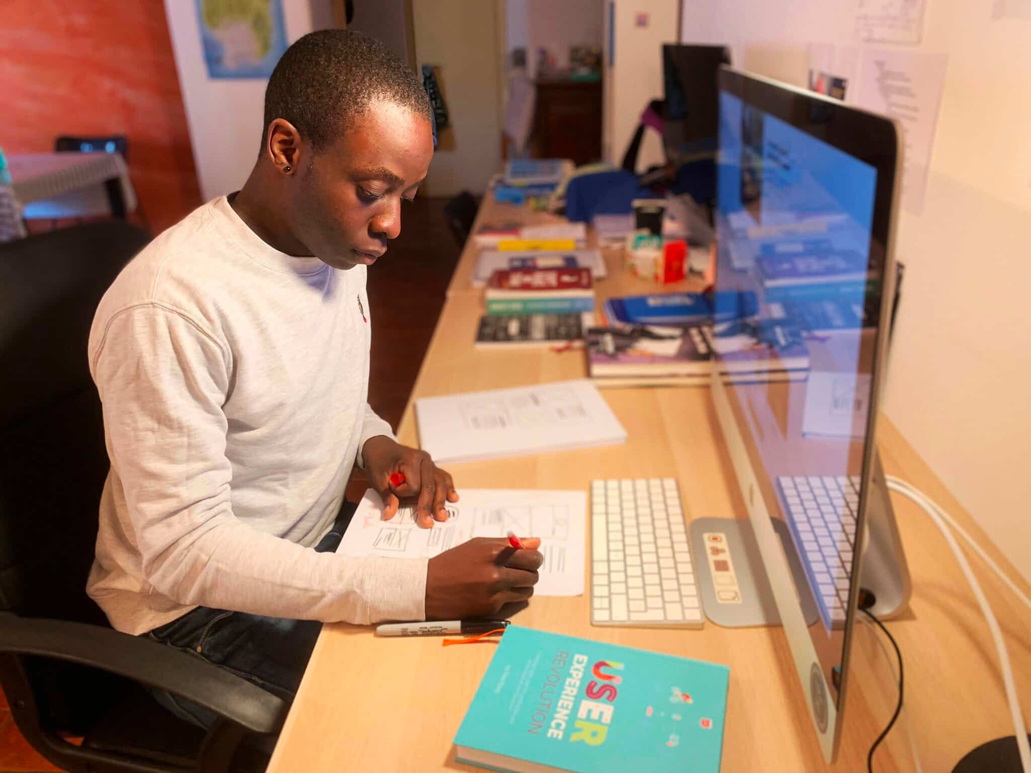 Jerome Kalumbu working at his home office in Milan